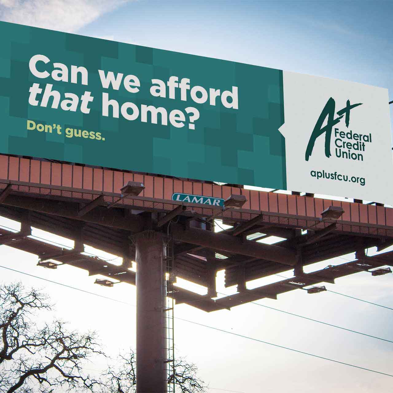 An outdoor advertisement (bulletin) for A+ Federal Credit Union by Tilted Chair reading “Can we afford that home? Don‘t Guess.”